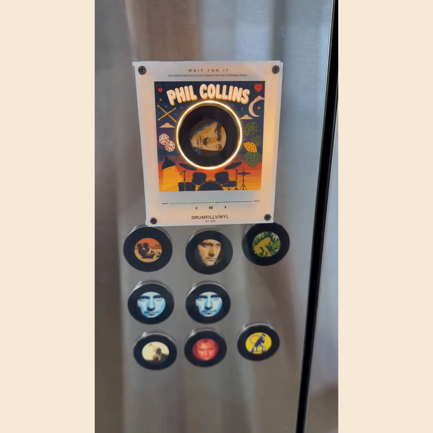 The Phil Collins vinyl frame and all nine magnet-backed discs on a fridge door