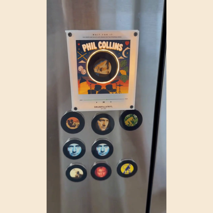 The Phil Collins vinyl frame and all nine magnet-backed discs on a fridge door