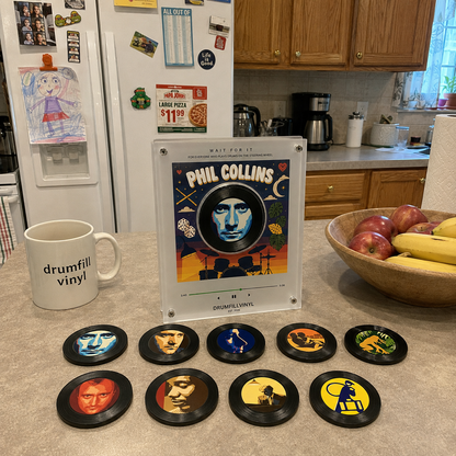 The Phil Collins vinyl frame on a kitchen counter with all nine discs in front of it